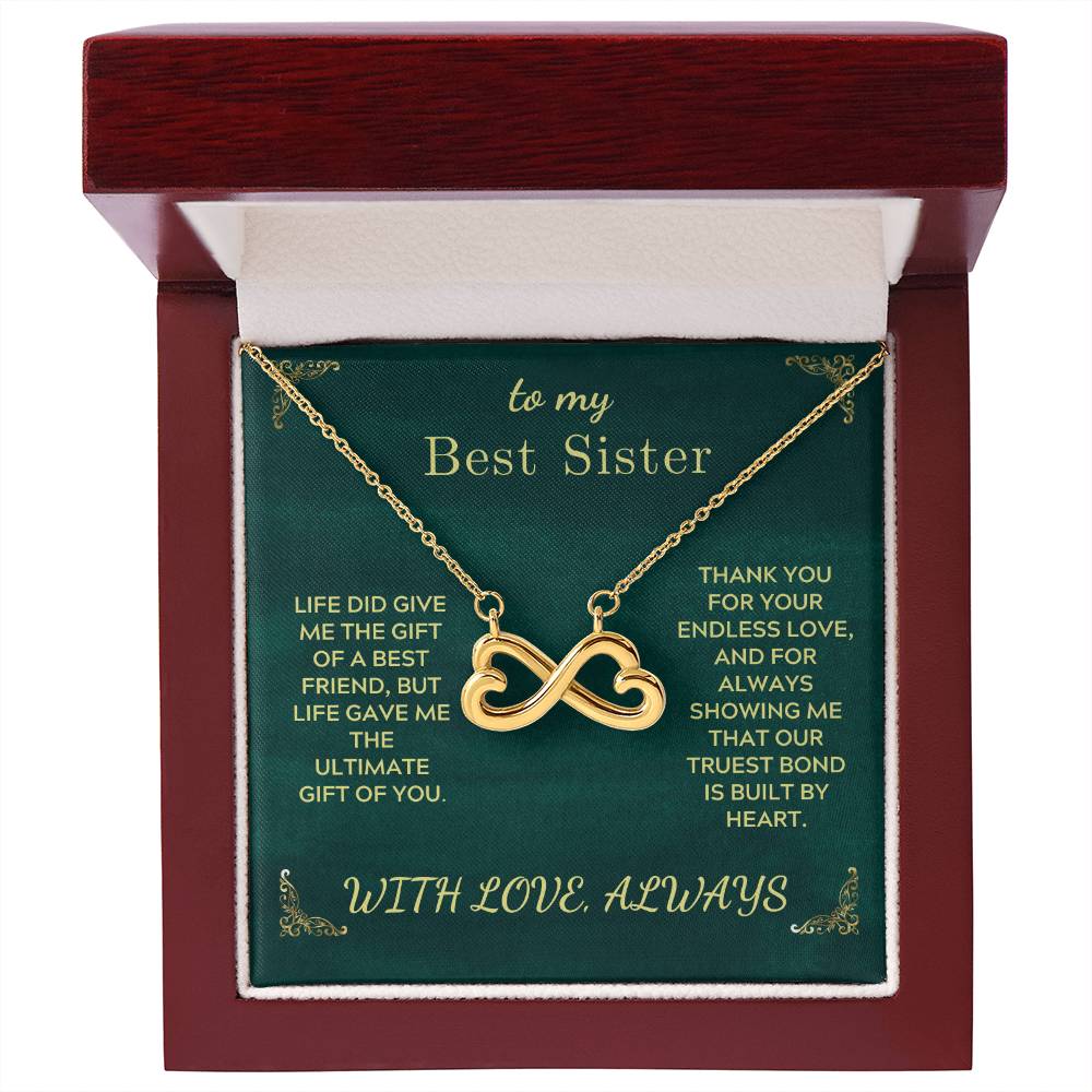 Gold-tone infinity heart sister necklace inside maroon gift box