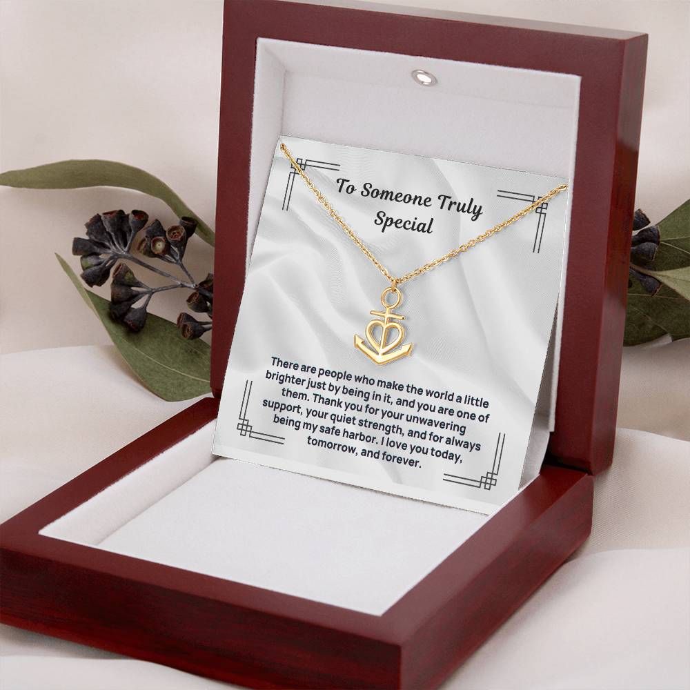 Gold-tone anchor heart pendant necklace on display card inside open gift box