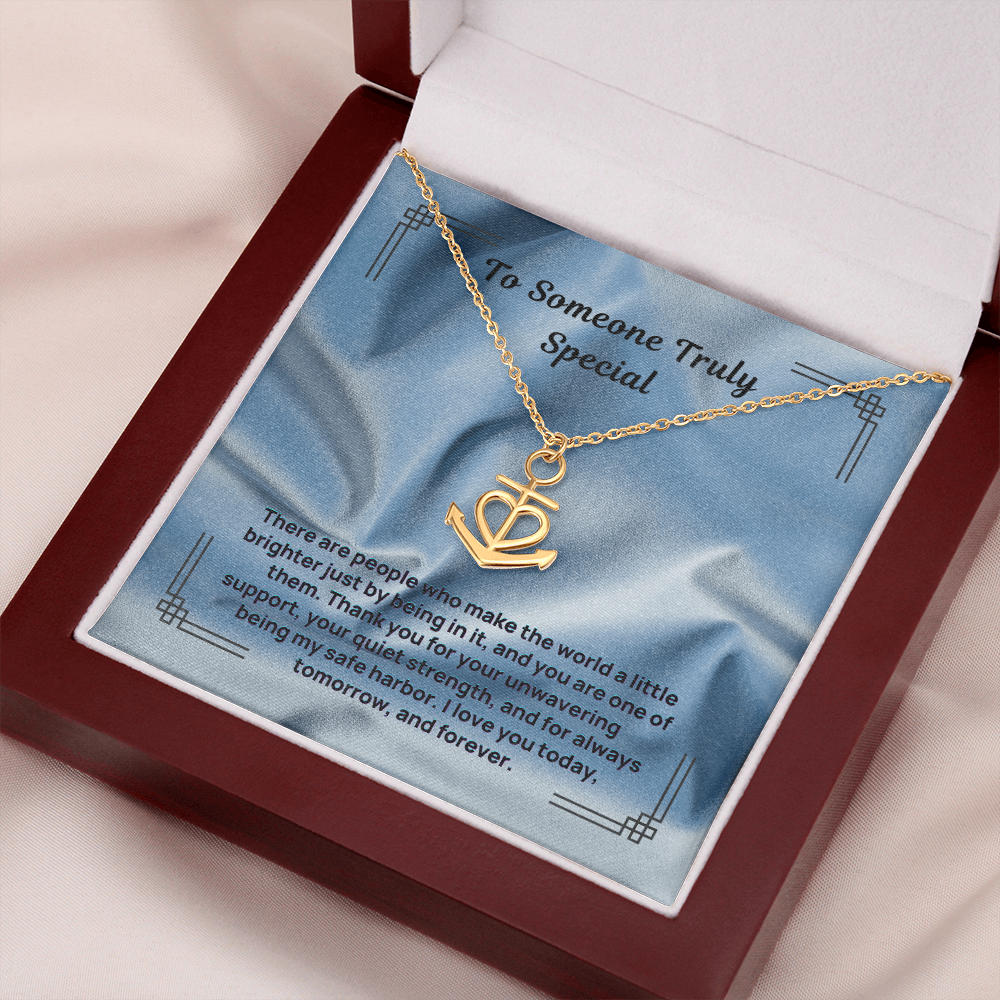 Gold anchor and heart pendant necklace with a linked chain in a gift box.