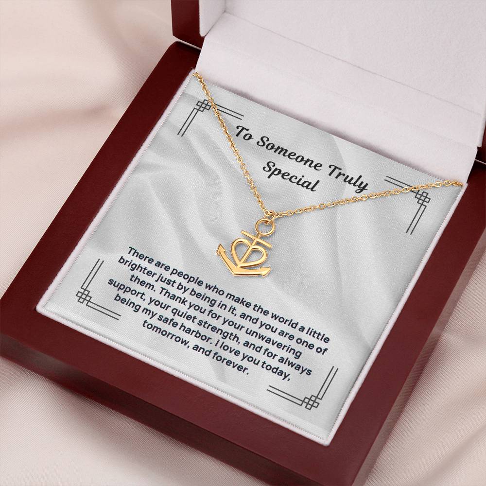 Gold-tone anchor heart pendant necklace on white display card in box