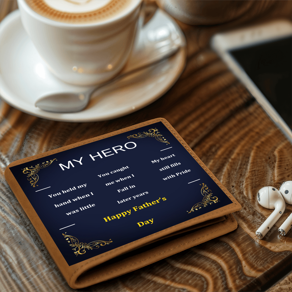 Brown leather wallet with navy “MY HERO” design on a wooden table