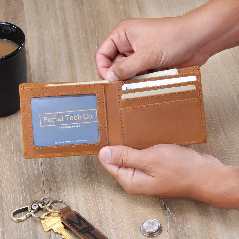 Brown leather wallet open with card slots and branded card pocket