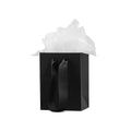 Black paper gift bag with twisted handles and white tissue paper topper