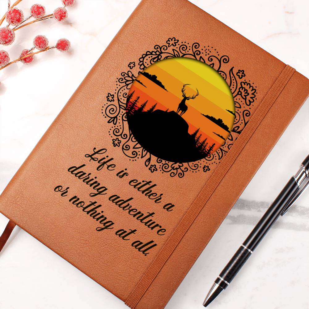 Orange leather-look journal with rider emblem and script quote, close-up front