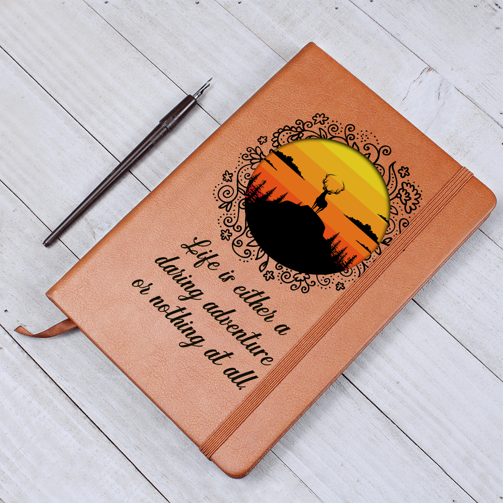 Orange leather-look journal with rider emblem and script quote, angled view