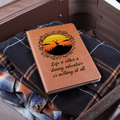 Orange leather-look journal with rider graphic and script quote on front cover