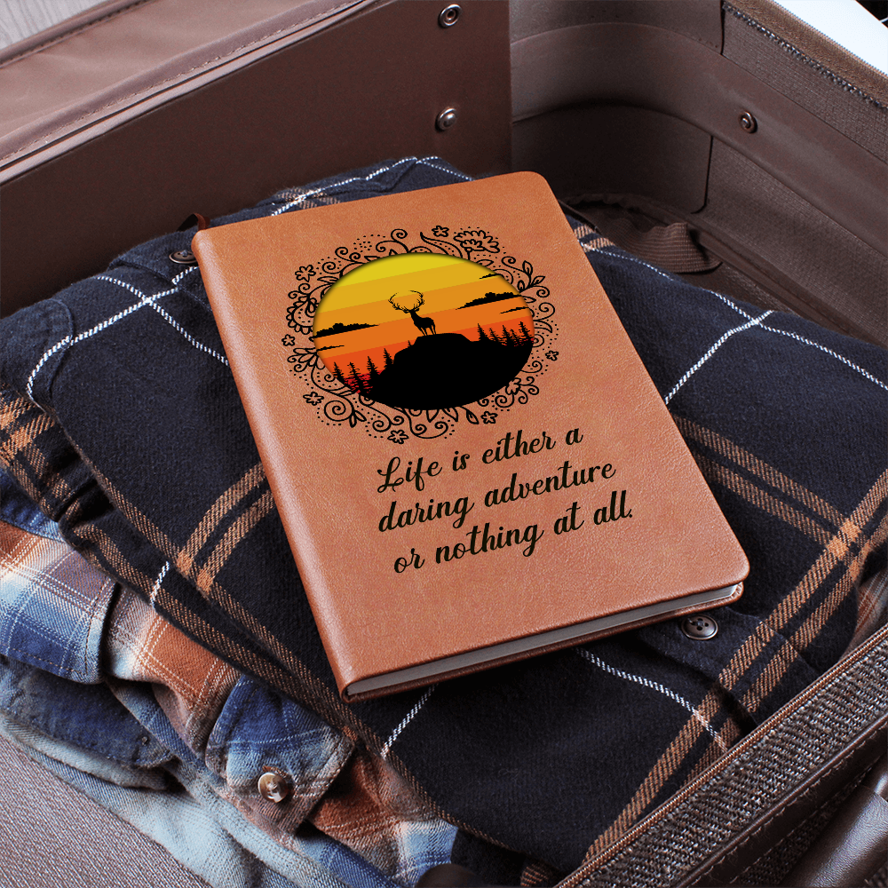 Orange leather-look journal with rider graphic and script quote on front cover