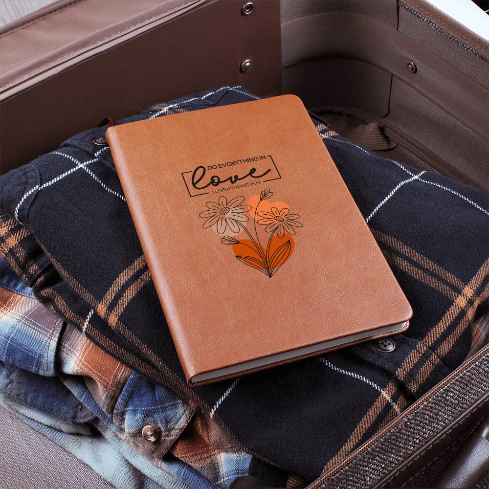 Orange-brown journal with floral heart design and scripture quote on the cover