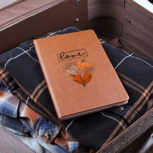 Orange-brown journal with floral heart design and scripture quote on the cover
