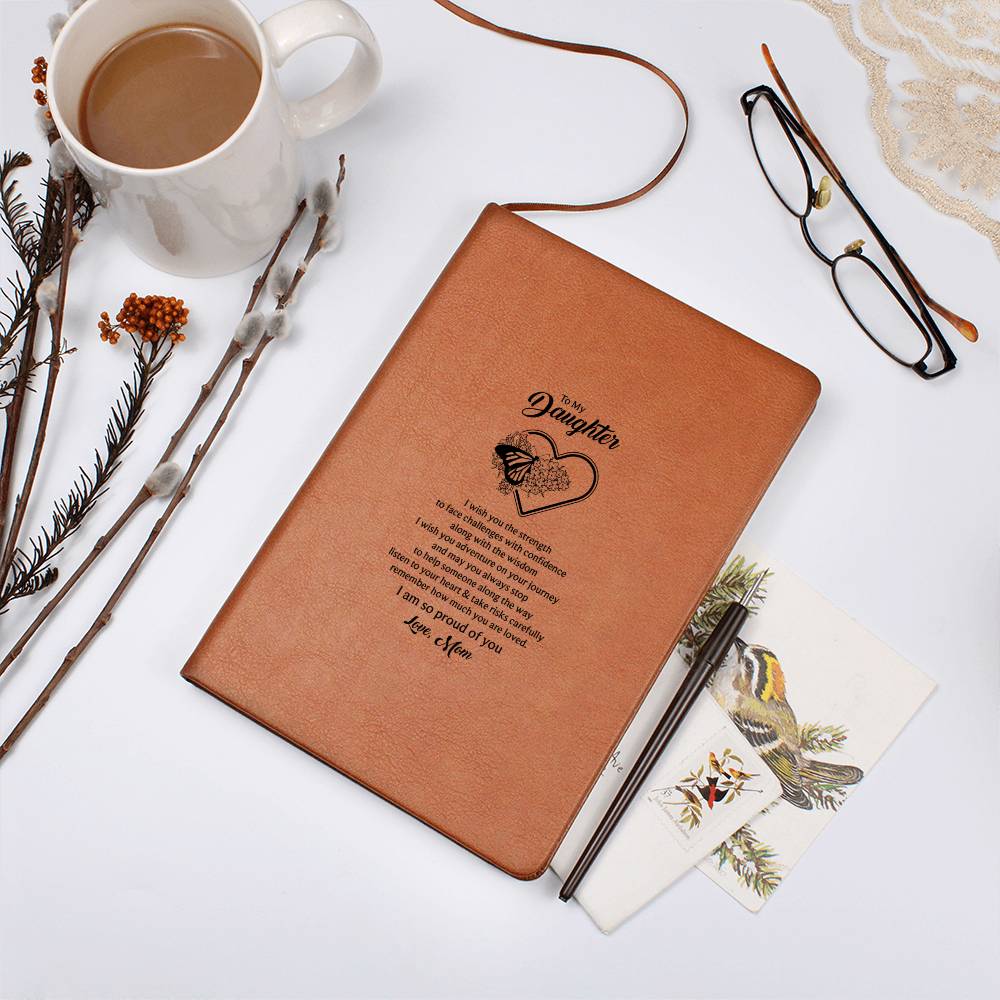 Orange-brown journal notebook with heart-and-butterfly text design, top view