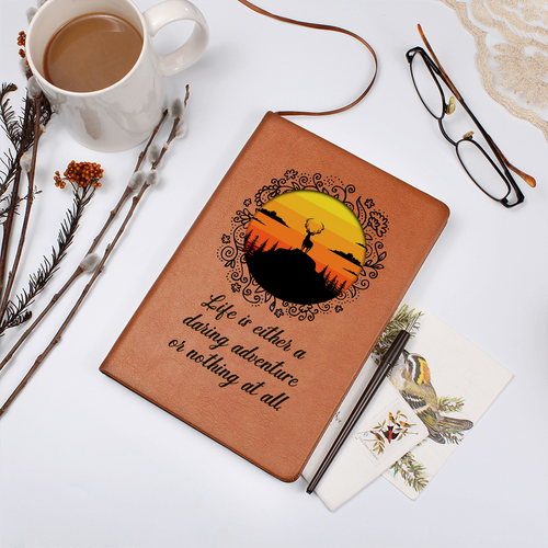 Orange leather-look journal with rider emblem and script quote on front cover