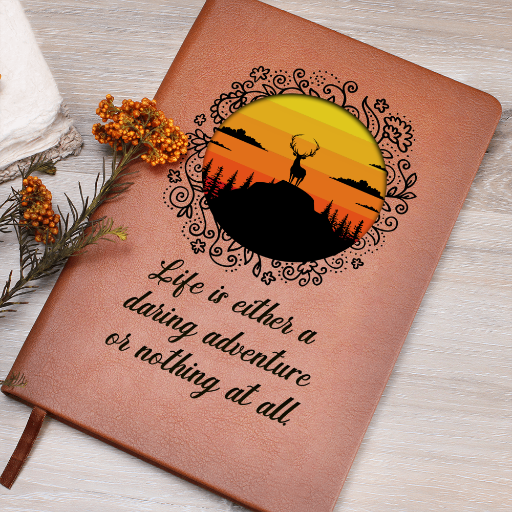 Orange leather-look journal with rider emblem and script quote on cover