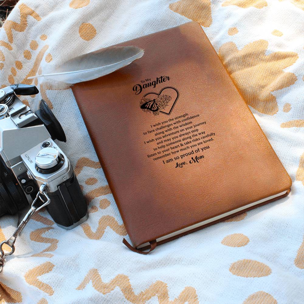 Orange-brown notebook journal with heart-and-butterfly quote shown on fabric
