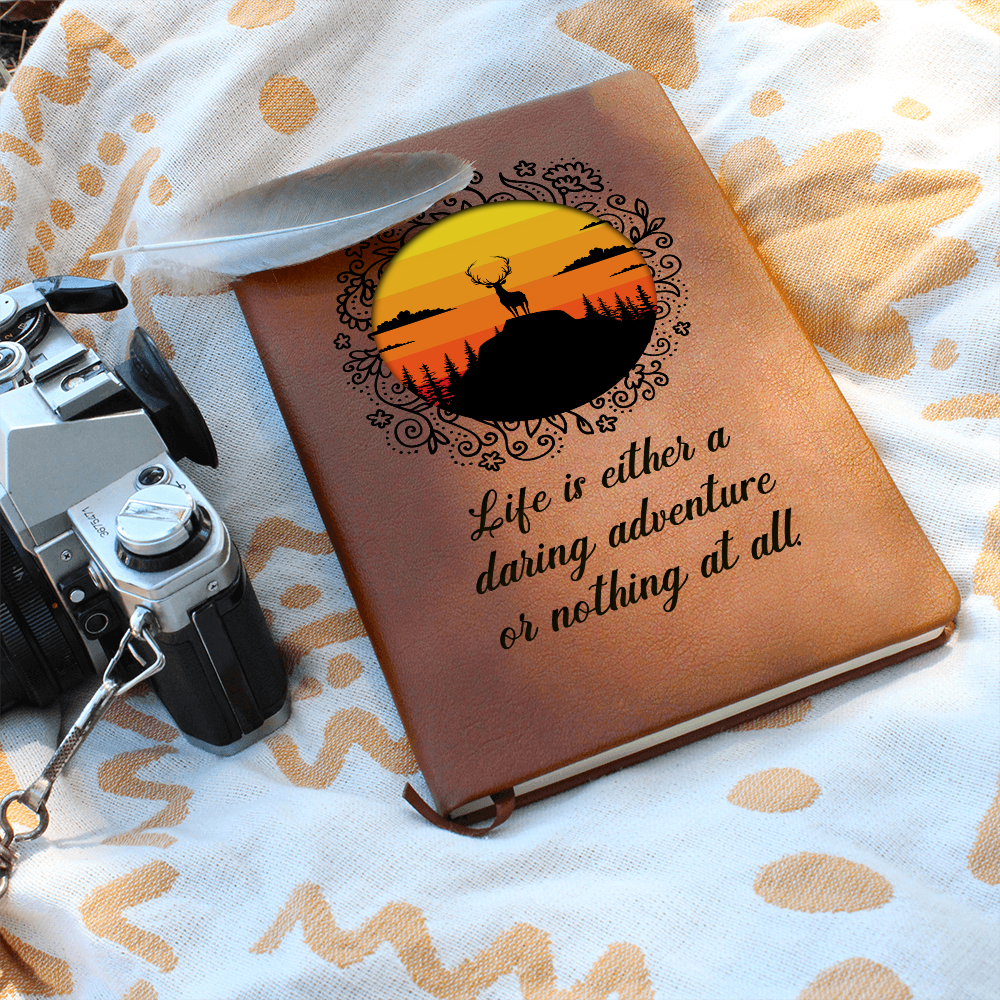 Orange leather-look journal with rider emblem and script quote on front cover