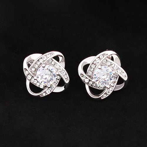 Love knot stud earrings, silver-tone with round clear stones and central opal-like gem