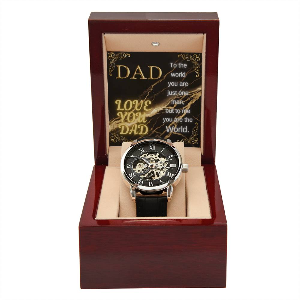 Open wooden watch box with black leather strap and skeleton dial timepiece