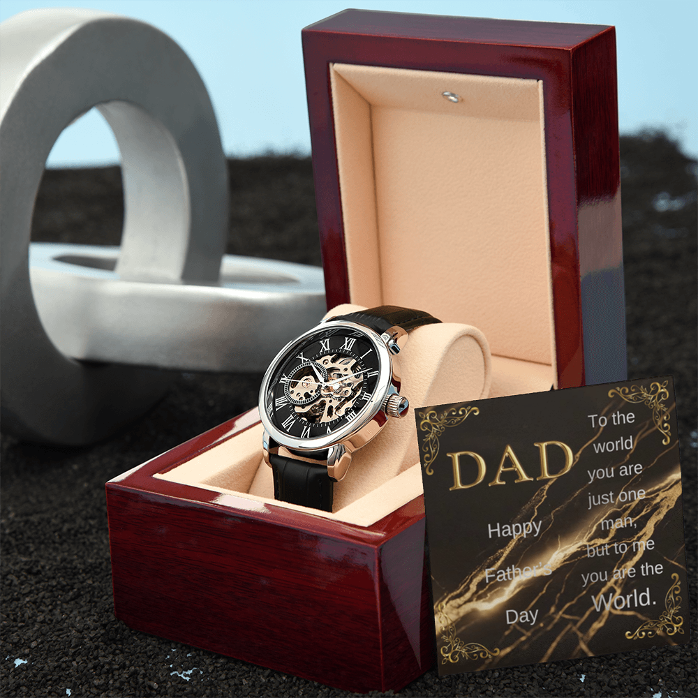Wood watch box with DAD message card and black leather open-work wristwatch on cushion