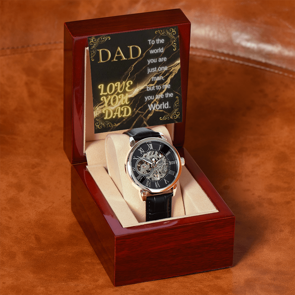 Open wooden watch display box with black strap and ornate openwork dial watch