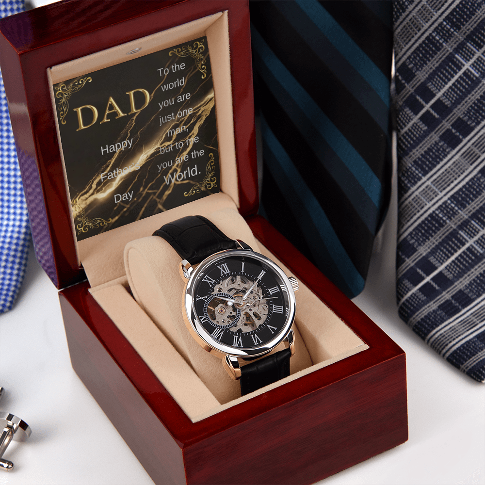 Wood watch box with DAD message card and black leather skeleton wristwatch, angled view