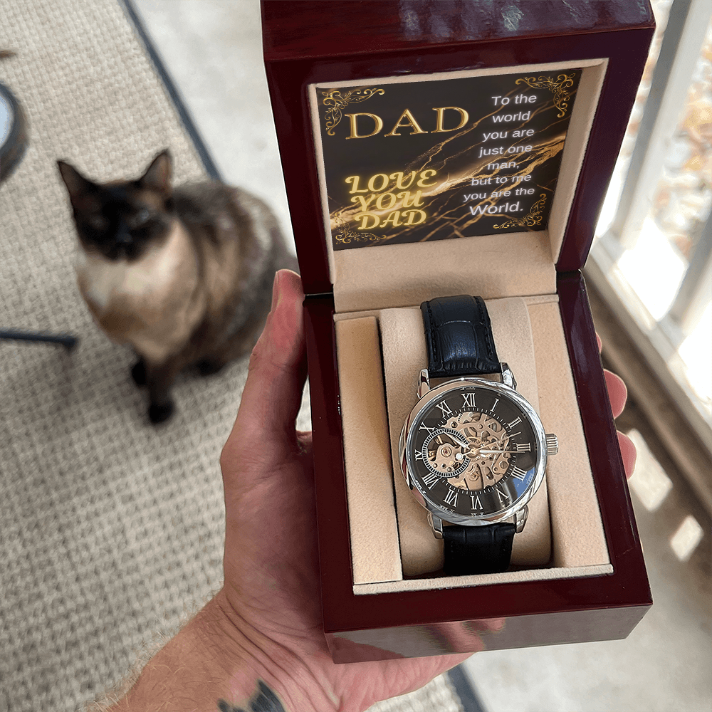 Watch in maroon wooden box with black leather strap and skeleton-style dial