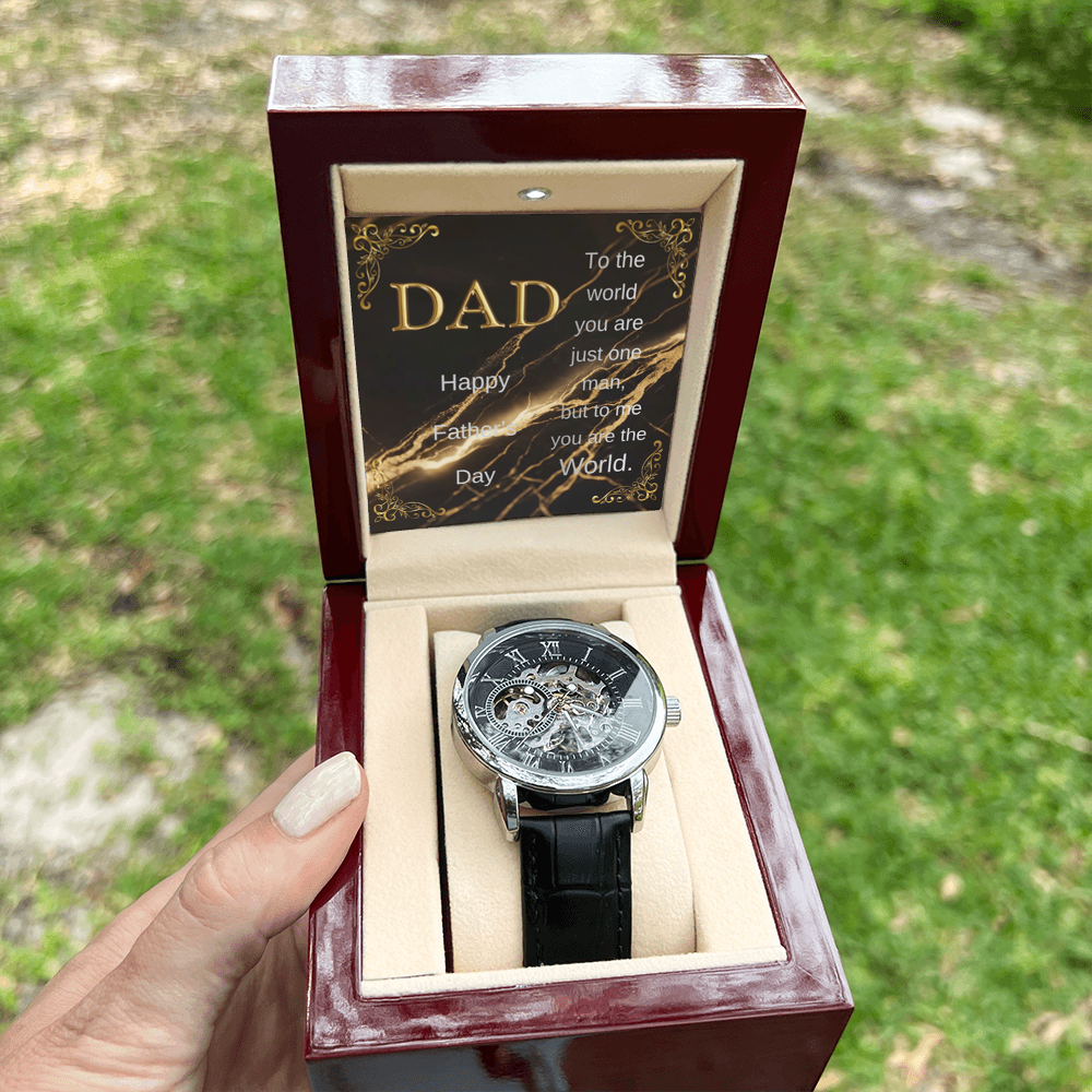 Wood watch box with DAD message card and black leather open-work wristwatch, front view