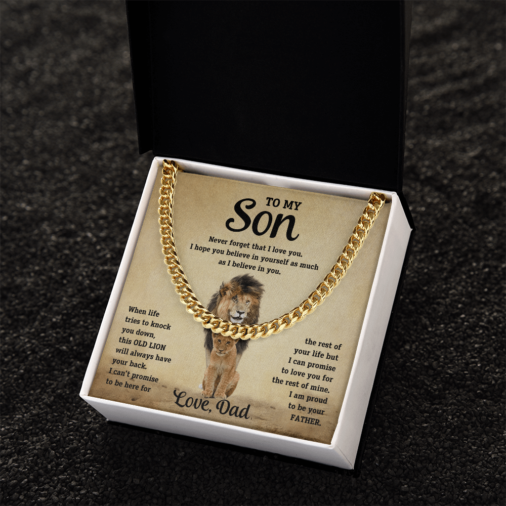 Gold-tone curb-link necklace in white gift box on dark surface