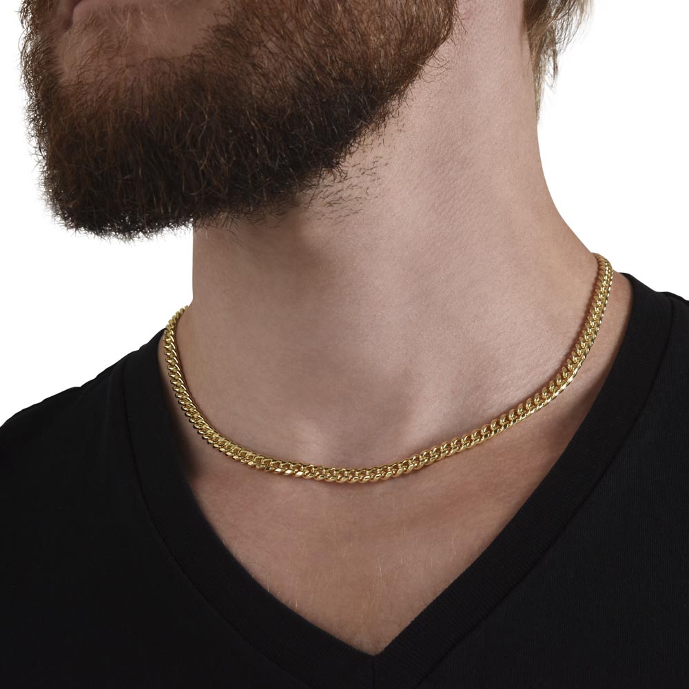 Gold-tone chain necklace worn on neck with black shirt