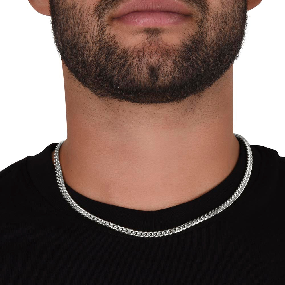 Silver-tone chain necklace worn on neck with black shirt