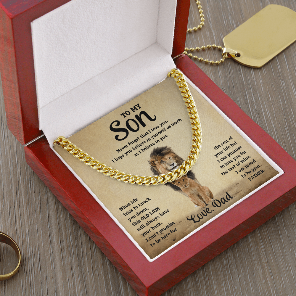 Gold-tone curb-link necklace resting in red gift box with lion message card