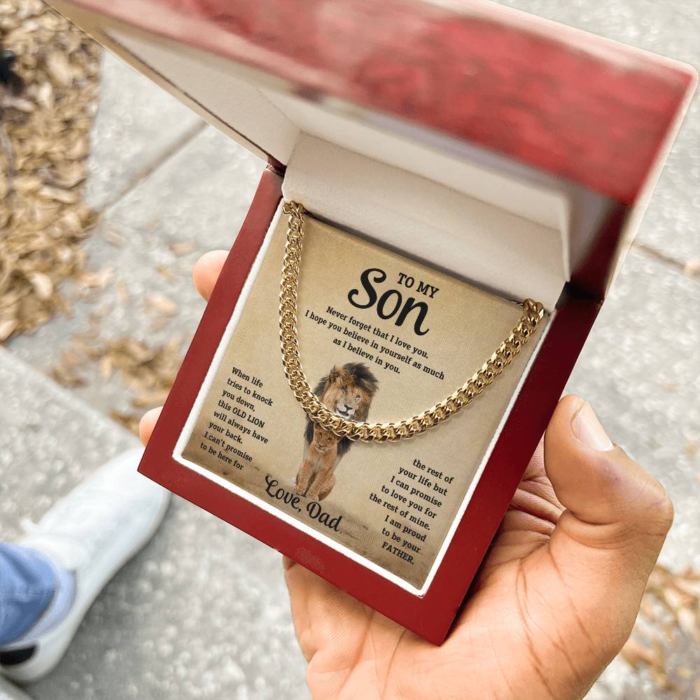 Gold-toned curb-link bracelet with dog portrait charm held in gift box