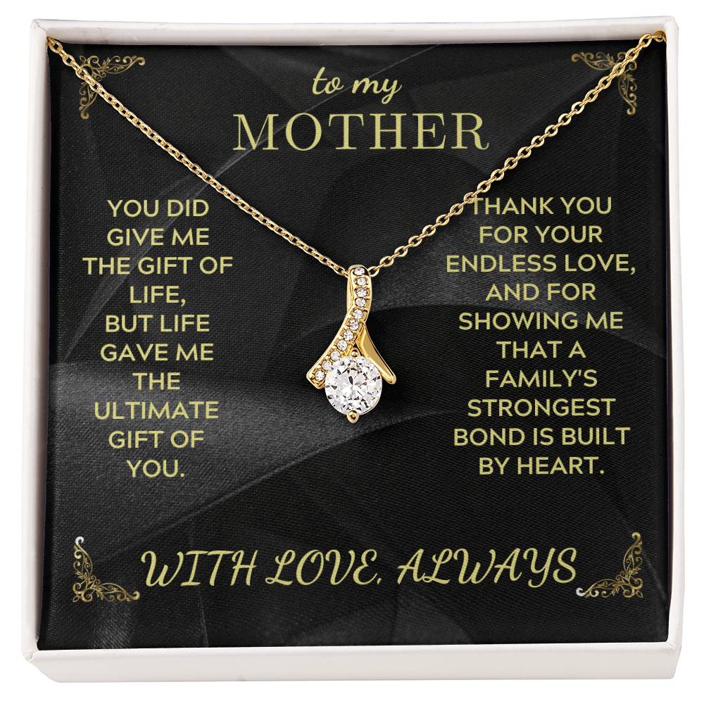 Gold-tone teardrop pendant necklace with rhinestone drops and link chain on black gift card