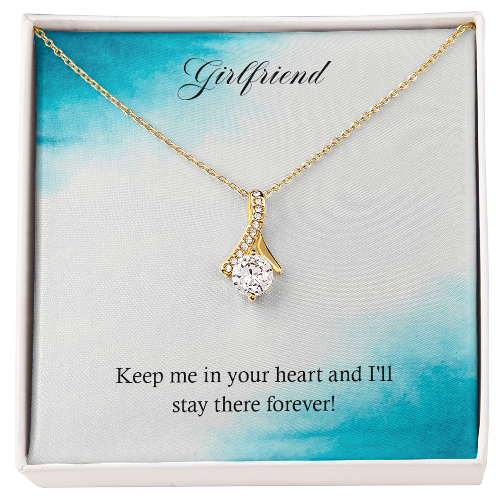 Gold-tone heart teardrop pendant necklace in a gift box with sparkling stones.