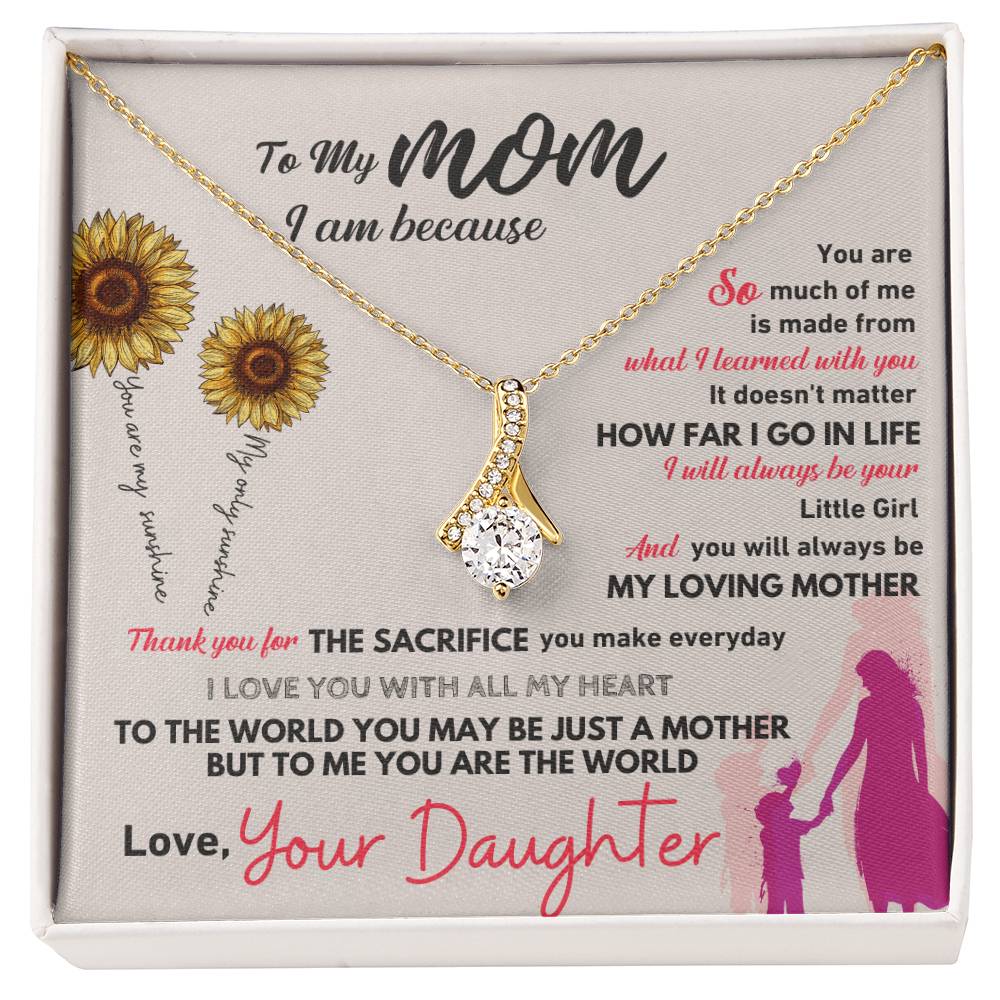 Gold-tone necklace with teardrop pendant on card in white gift box