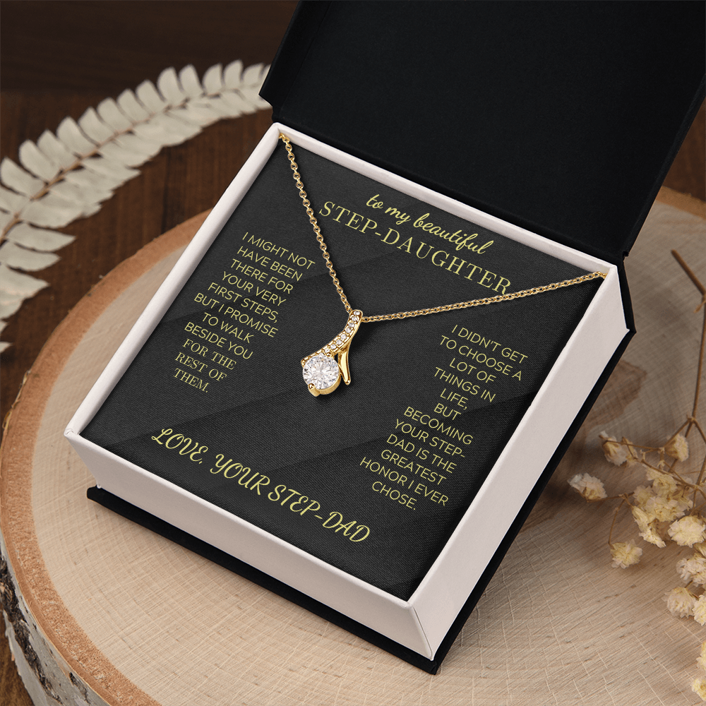 Gold-tone necklace with teardrop crystal charm, displayed in black insert gift box.