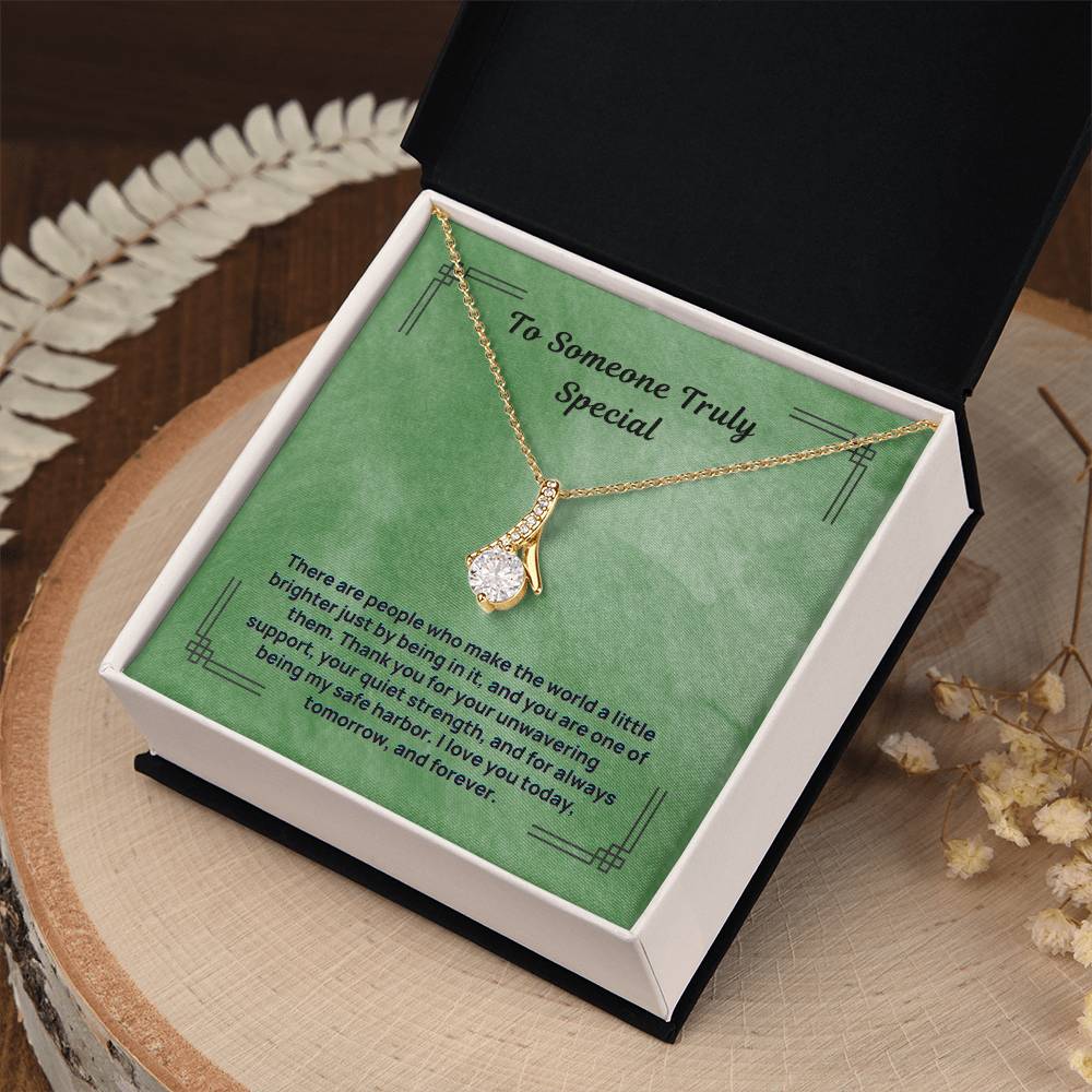Green message necklace with gold-tone chain and teardrop pendant, in open gift box
