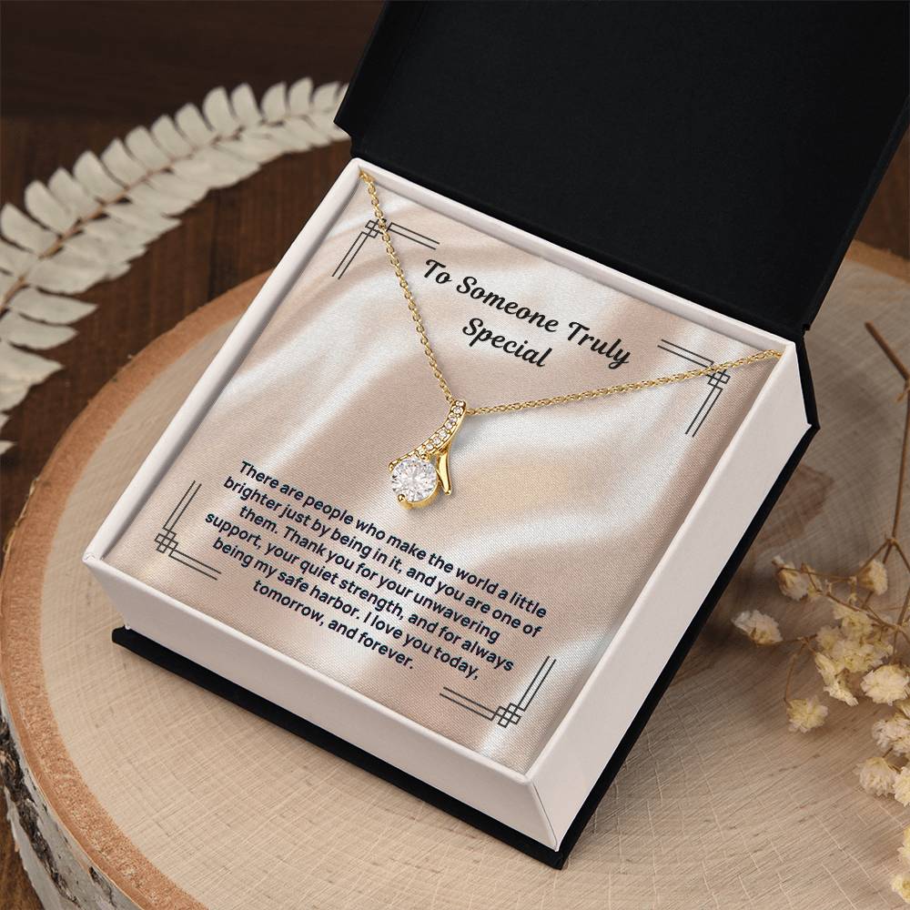 Gold-tone stone pendant necklace in black presentation box with card insert