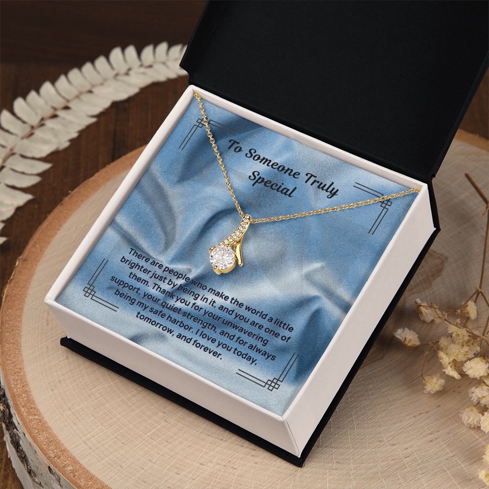 Gold-tone teardrop pendant necklace with blue message card in open gift box