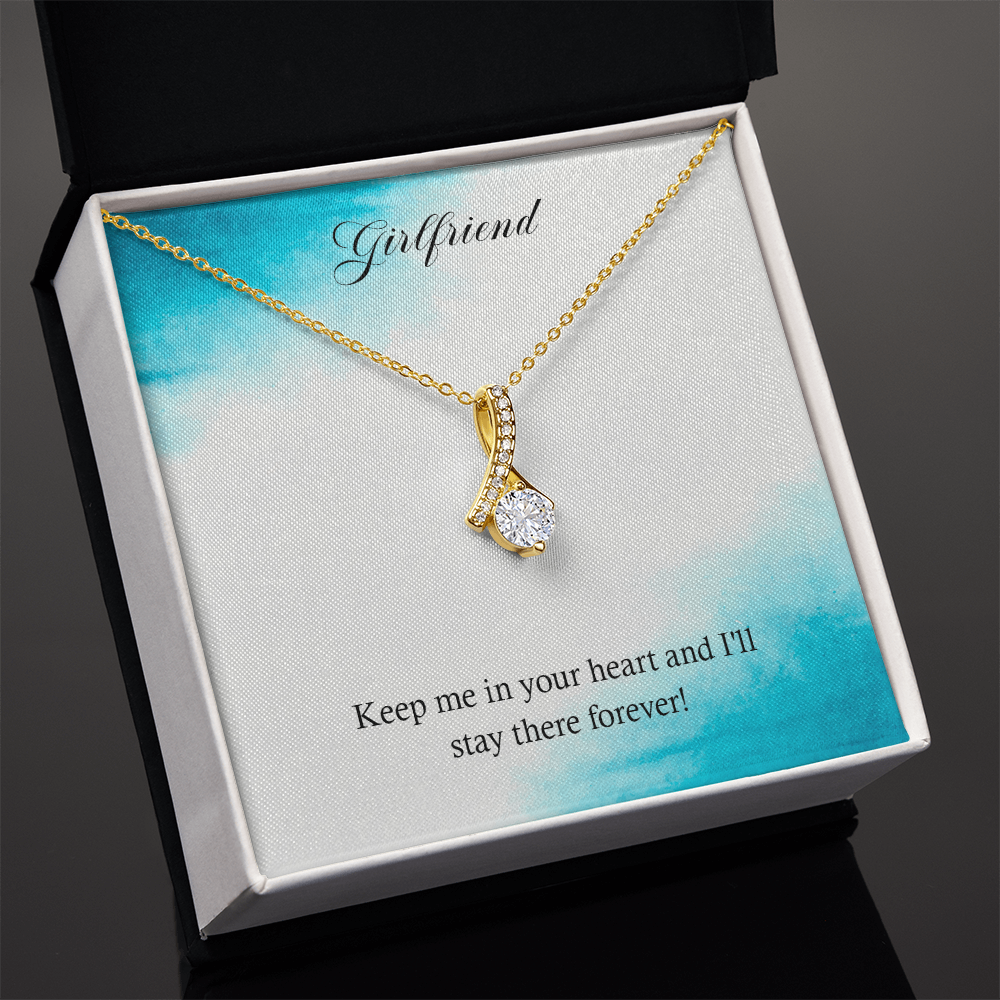 Gold-tone heart teardrop pendant necklace displayed in an open gift box.