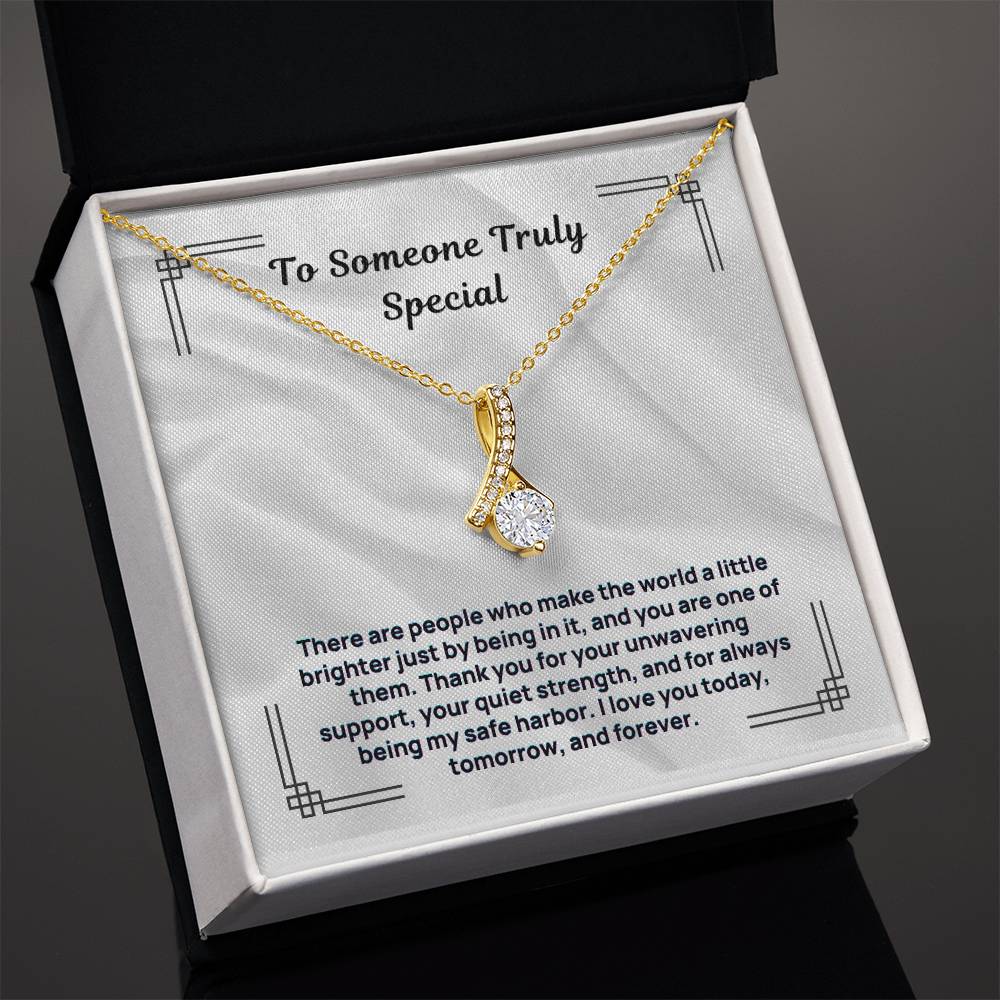 Gold-tone necklace with oval pendant and small crystal accents, in gift box