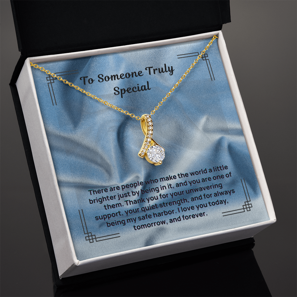 Gold teardrop pendant necklace with a round center stone and pave detail