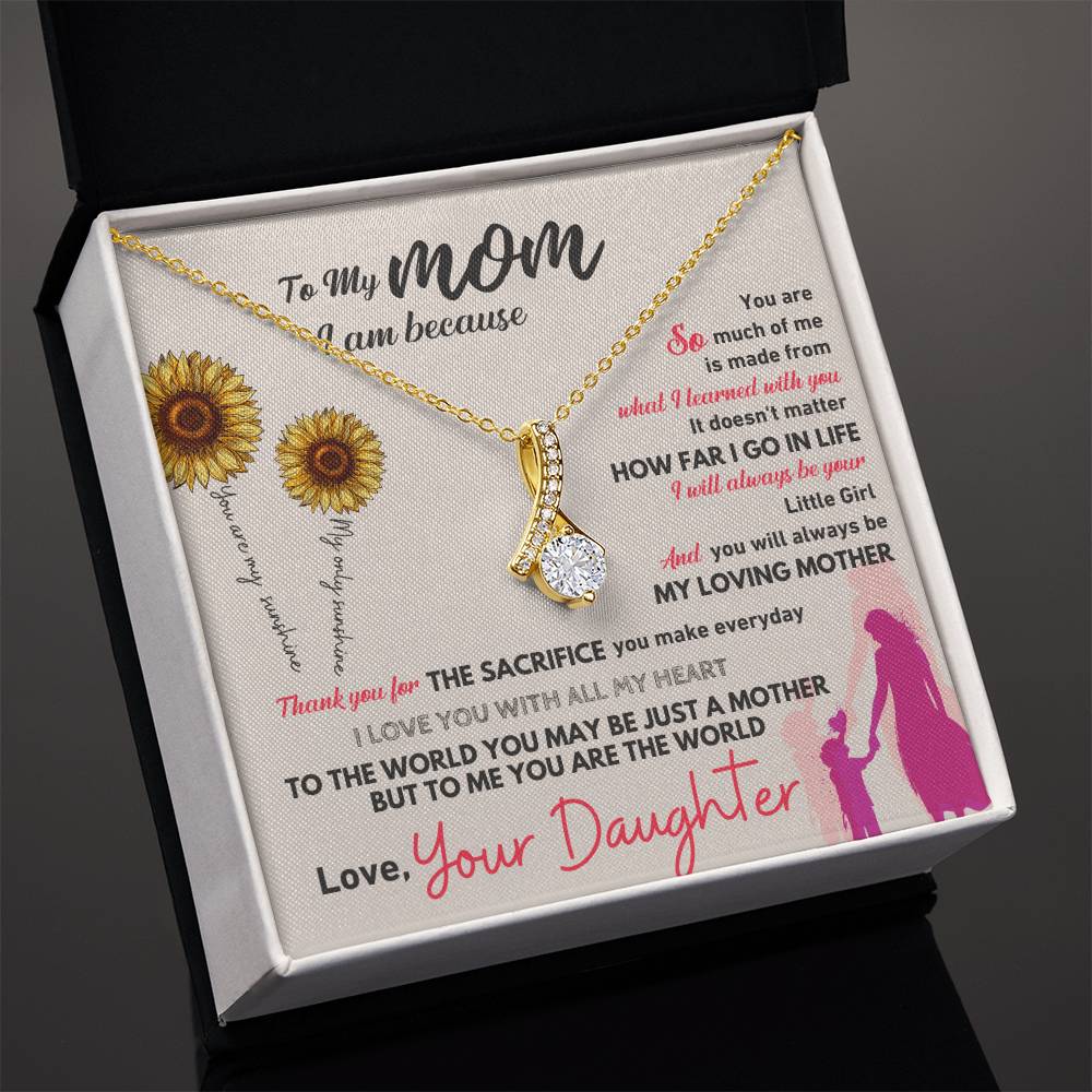 Gold-tone necklace with teardrop pendant in dark open gift box