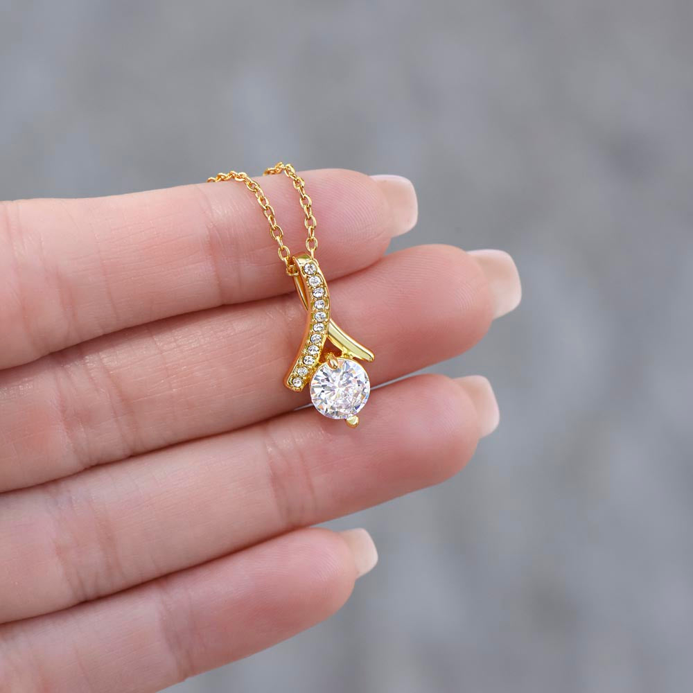 Gold-tone necklace with round clear pendant and pavé curve