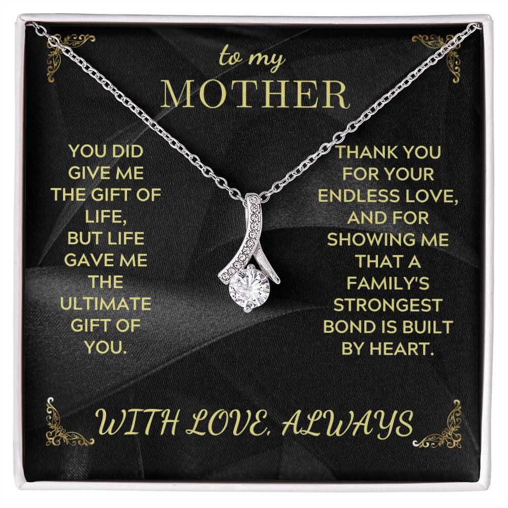 Silver-tone teardrop charm necklace with rhinestone cluster and fine link chain, gift box view