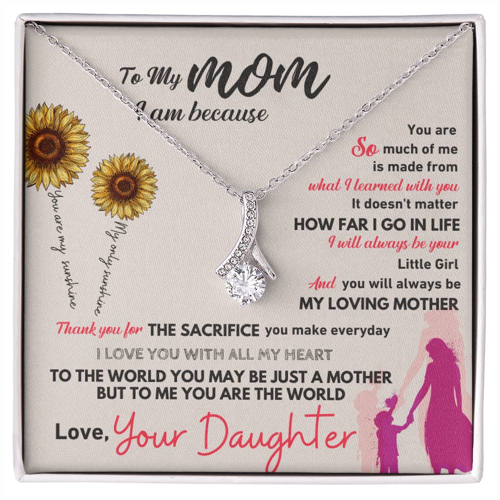 Silver-tone necklace with teardrop pendant on card in white gift box