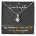 Silver-tone pendant necklace in a gift box, with teardrop charm and glittering stones.