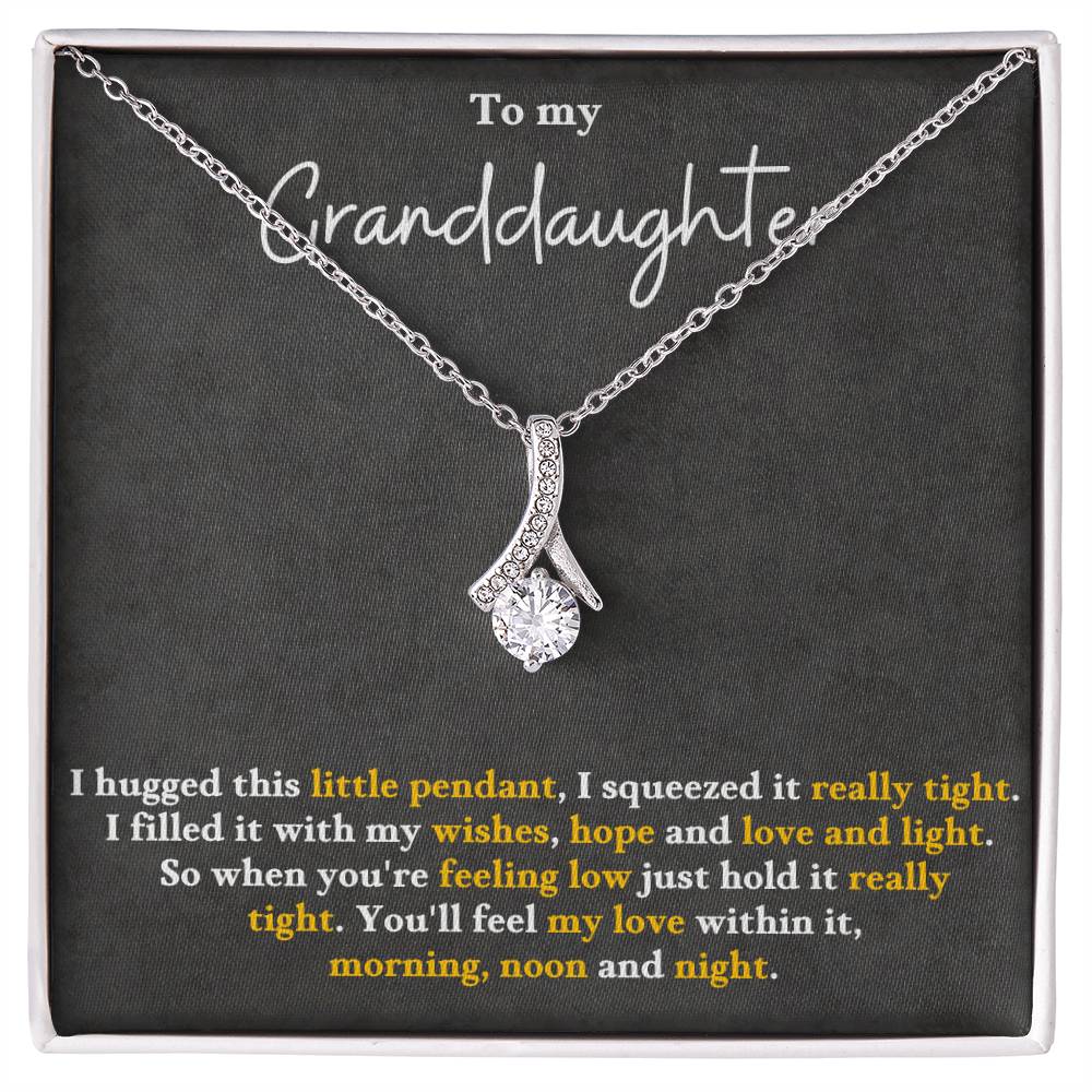 Silver-tone pendant necklace in a gift box, with teardrop charm and glittering stones.