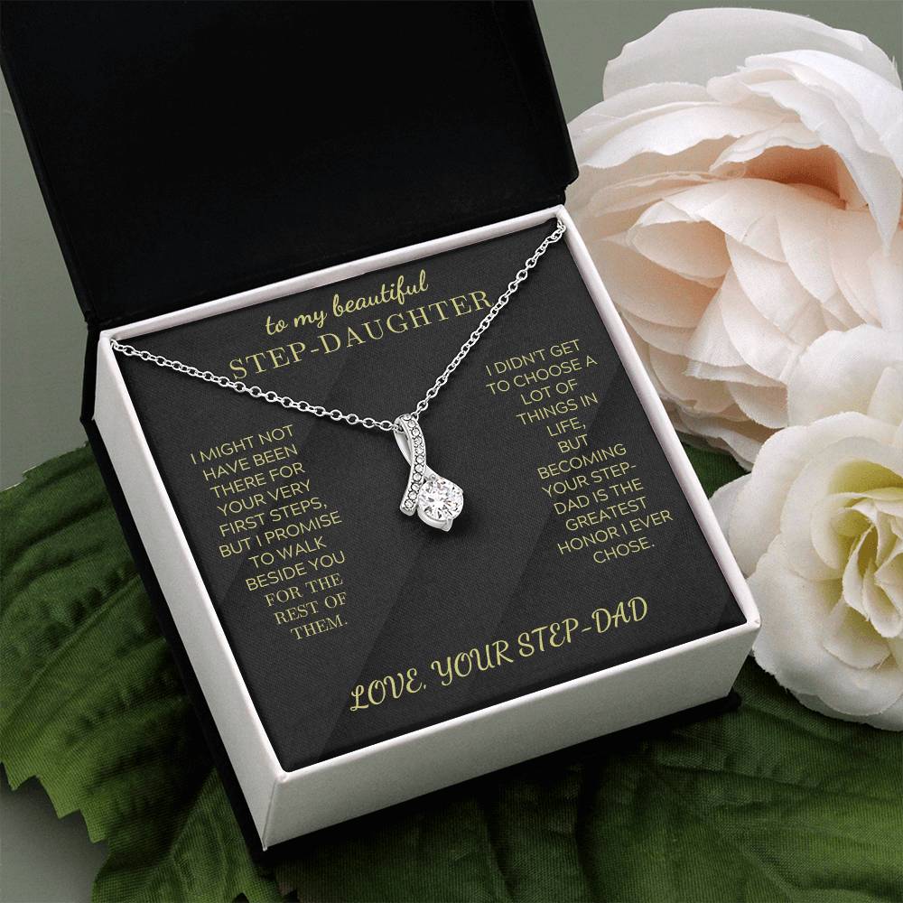 Silver-tone necklace with teardrop crystal pendant in black-lined gift box.
