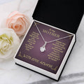 Silver-tone teardrop pendant necklace shown in a purple gift box