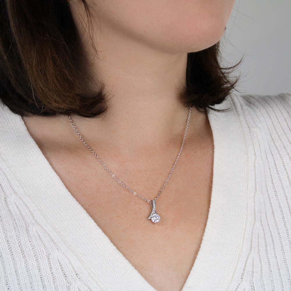 Silver-tone necklace with heart and teardrop crystal pendant on neckline