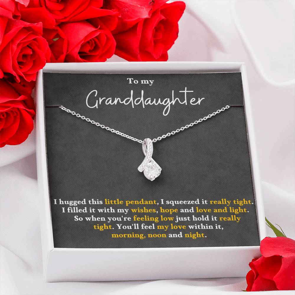 Silver-tone pendant necklace set in a gift box, with teardrop charm and small stones.